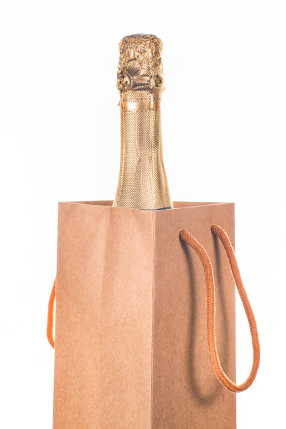 istock Champagne bottle into gift bag isolated 1076852438