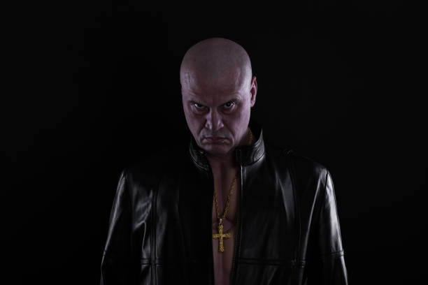 istock studio portrait of a biker on a black background 1076852580