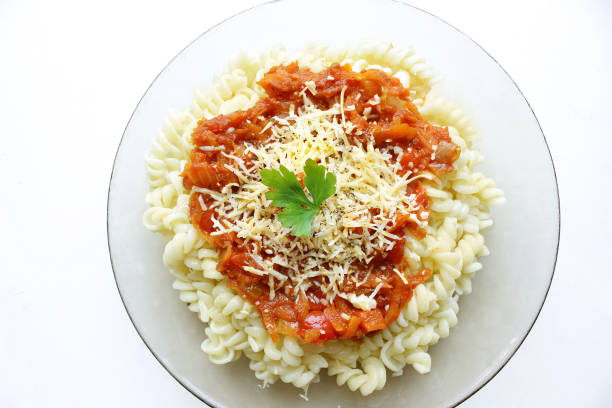 istock Pasta with tomato sauce, grated cheese and parsley 1076853784
