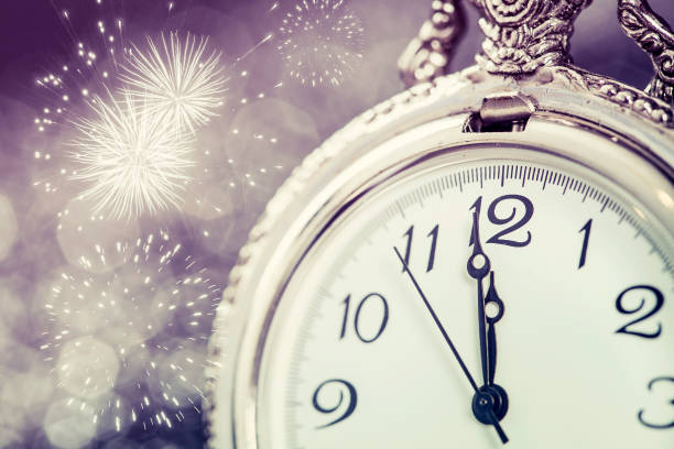 istock New Year's at midnight - Old clock and holiday lights 1076856720