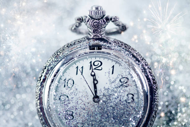 istock New Year's at midnight - Old clock and holiday lights 1076857582