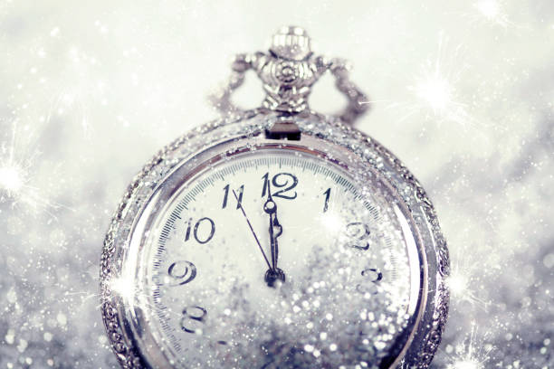 istock New Year's at midnight - Old clock and holiday lights 1076857914