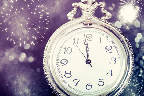istock New Year's at midnight - Old clock and holiday lights 1076861700