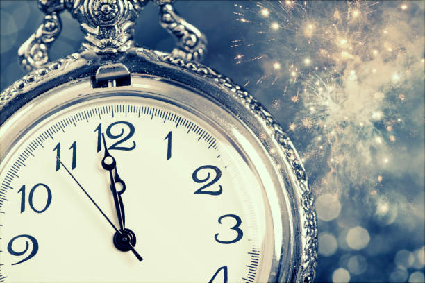 istock New Year's at midnight - Old clock and holiday lights 1076861900