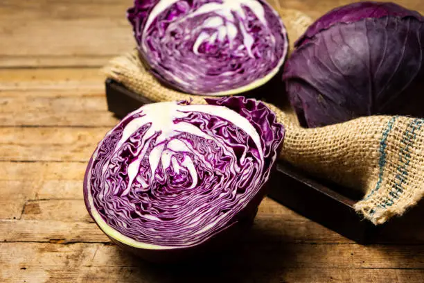 Purple cabbage on a rustic wooden table top view