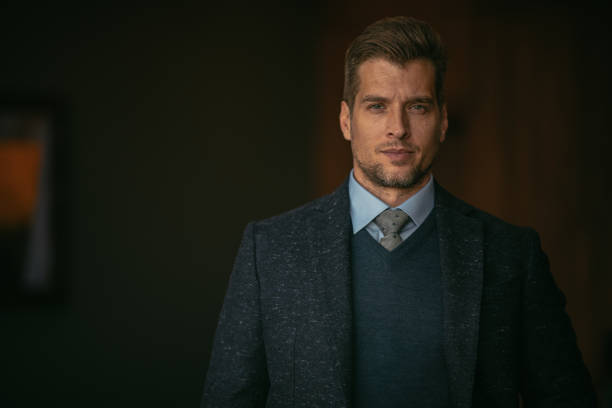 Handsome businessman in office. Shallow DOF. Developed from RAW; retouched with special care and attention; Small amount of grain added for best final impression. 16 bit Adobe RGB color profile.