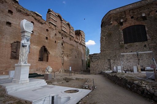 Photo includes sculpture and exterior view of Red Basilica at Bergama