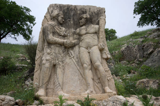 handshake relief of hercules and antiochus near a greek tablet in arsemia ancient region - nemrud dagh mountain turkey history imagens e fotografias de stock