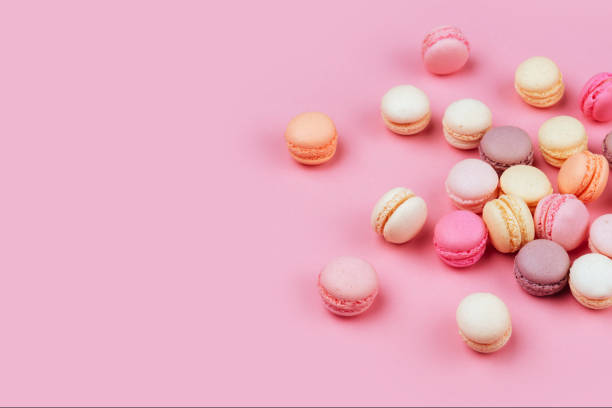 istock Different types of macaroons on pink background. 1076872912