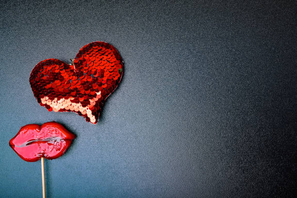 istock clouse up of red heart, lips on black background 1076873146