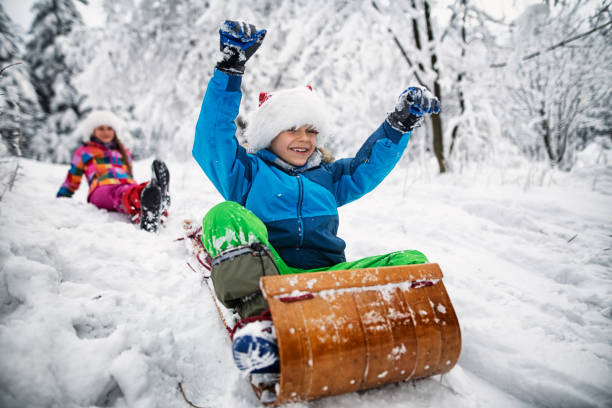 istock Kids tobogganing on Christmas 1076873866