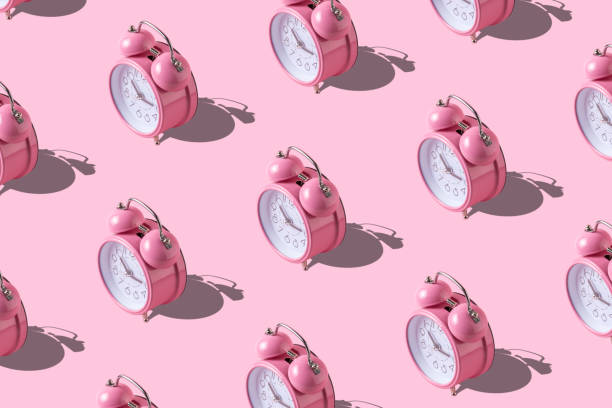 istock Creative layout of pink alarm clock's on pastel pink background. 1076873944