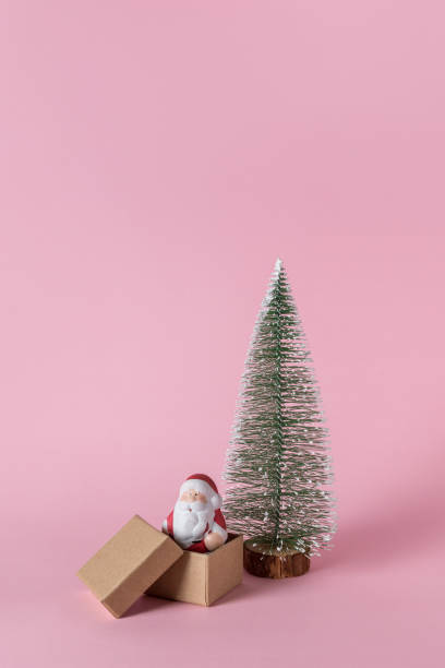 istock Small Santa Claus with gift boxes on pink background. Minimal Ch 1076873980