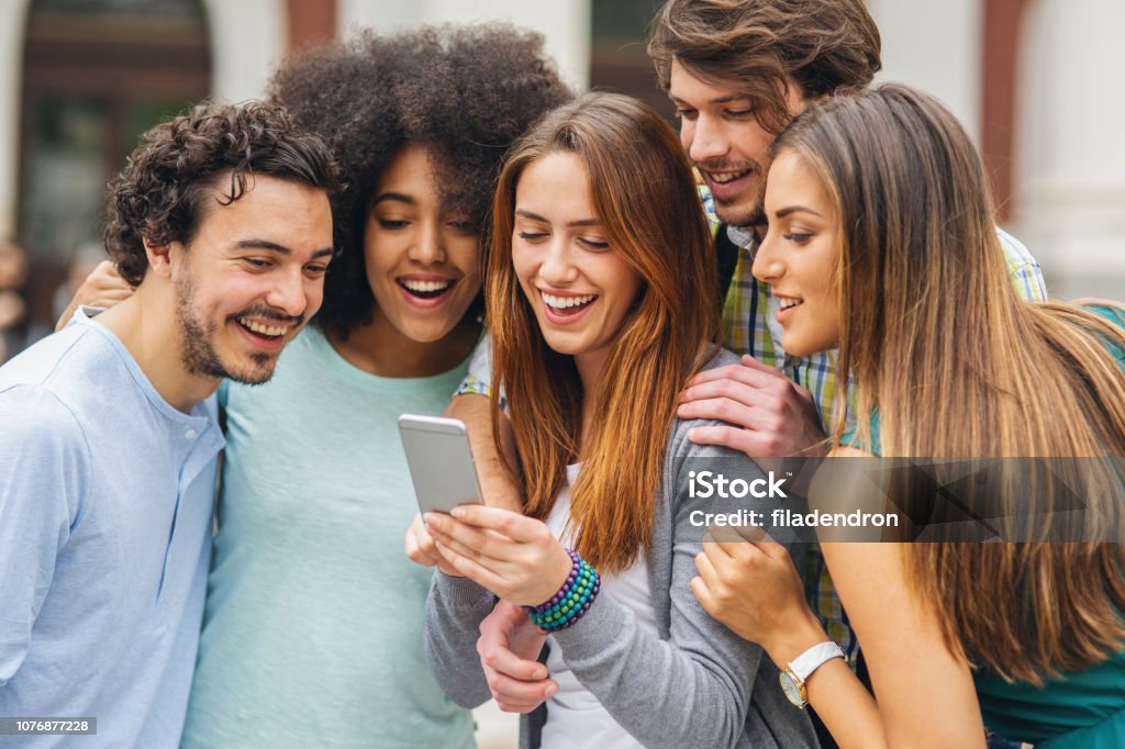 Group Of Friends Are Watching Funny Videos Stock Photo - Download Image Now  - Men, Showing, 20-29 Years - iStock