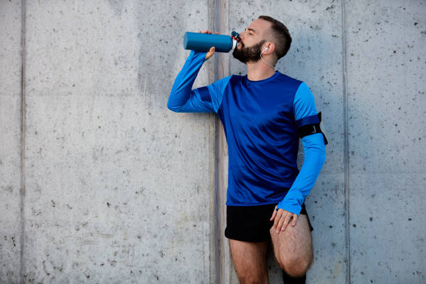 istock Man resting from running and drinking water. 1076881854