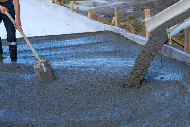 istock Workers pour the Foundation for the construction of a residential building using mobile concrete mixers. 1076882104