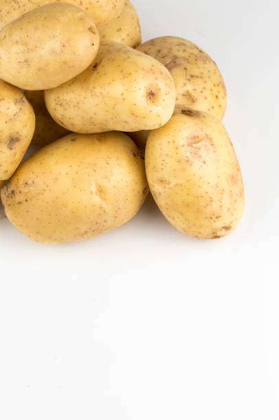 istock Fresh organic vegetables; potatoes on the white background. 1076882416