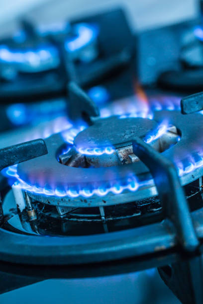 istock Close-up kitchen stove cook with blue flames burning. 1076886622