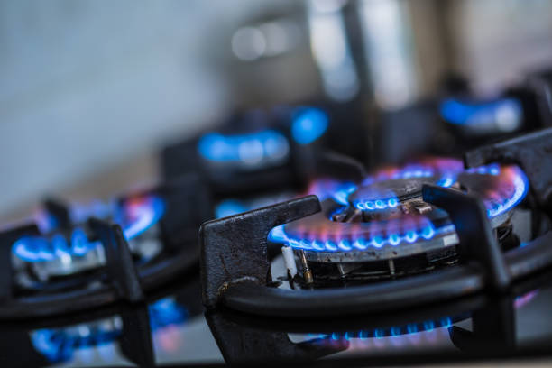 istock Close-up kitchen stove cook with blue flames burning. 1076886624
