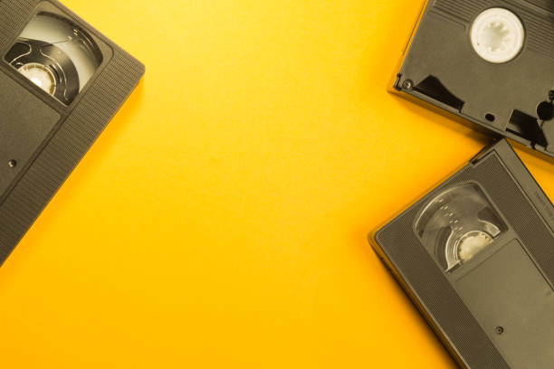 istock Video cassette isolated on yellow background. cassette with copy space 1076889250