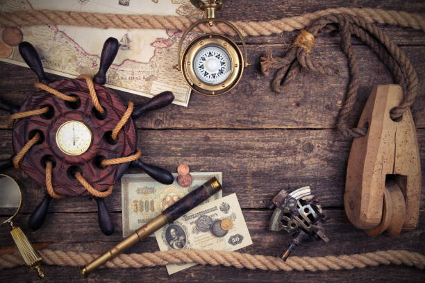 istock Old ship steering wheel,compass,coins,monocle,loupe, sextants,rope,candle and pirate map. Travel and marine engraving background. Treasure hood concept. Vintage style. 1076889792