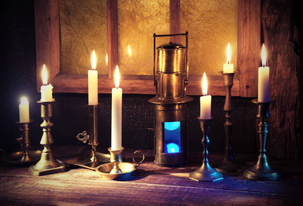istock Burning candles,old candlestick and vintage ship lantern.Background with retro window frame.The holiday mood 1076889866