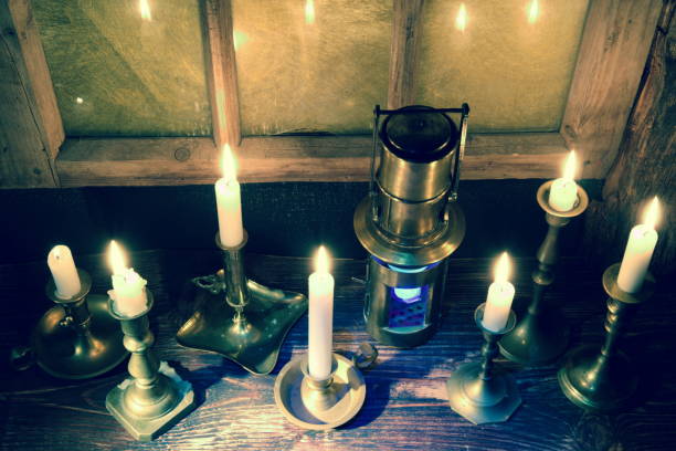 istock Burning candles,old candlestick and vintage ship lantern.Background with retro window frame.The holiday mood 1076889880
