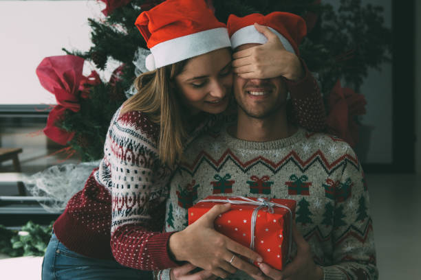 istock Young man receive Christmas gift from woman 1076903824