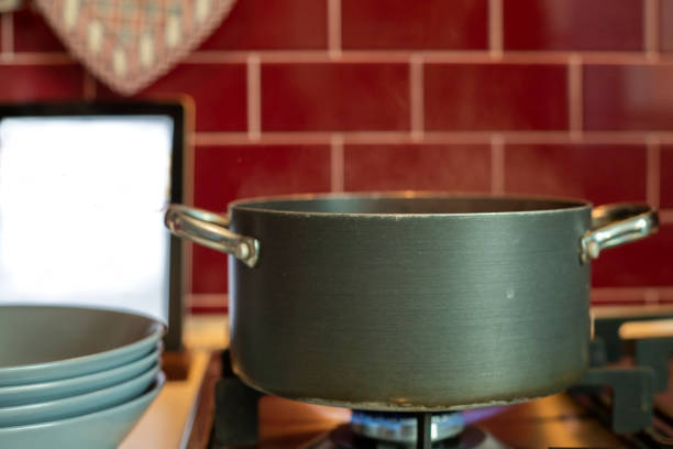 istock pot cooking on stove and tablet with blank screen. 1076915060
