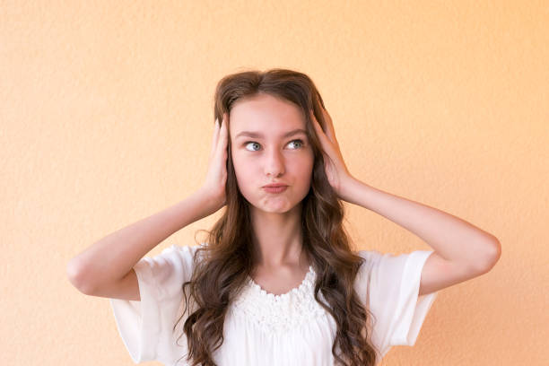 istock Lady in white dress closing ears with hands 1076921800