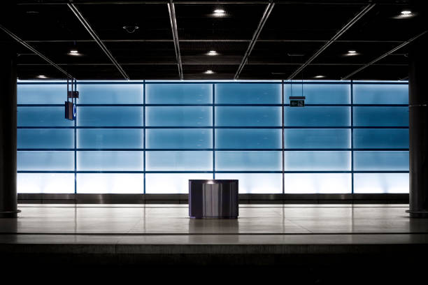 istock Empty railroad station platform - blue illuminated glass wall 1076922110