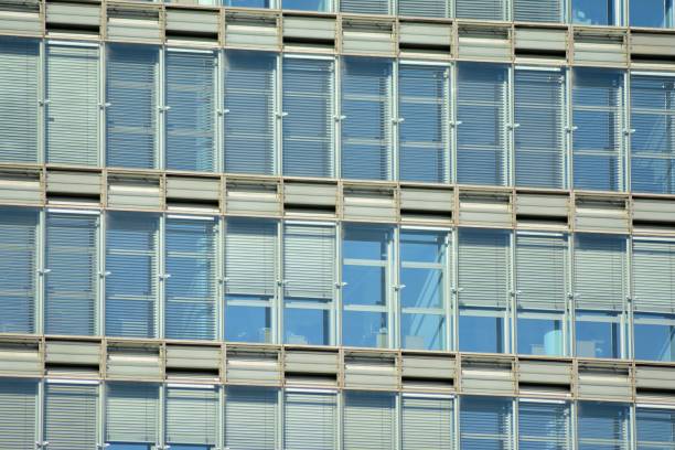 istock Modern office building facade abstract fragment, shiny windows in steel structure. 1076924024