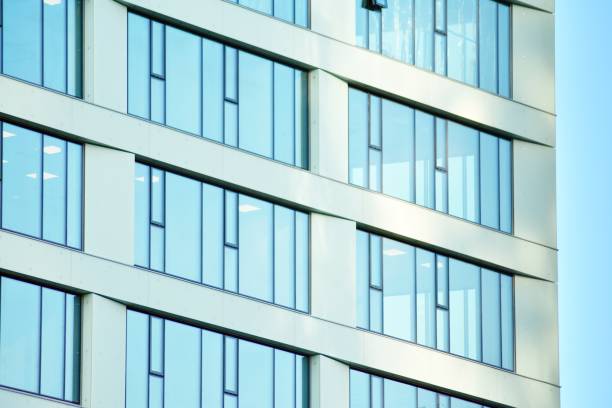 istock Modern office building facade abstract fragment, shiny windows in steel structure. 1076924324