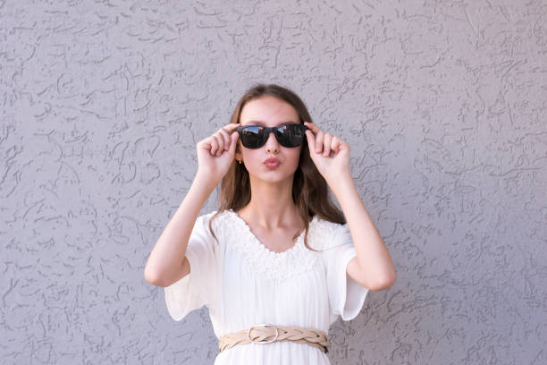 istock Young girl with sunglasses 1076927114