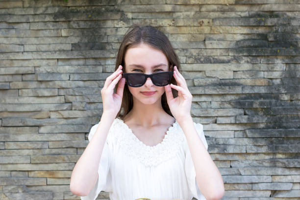 istock Cute girl posing in sunglasses 1076928396