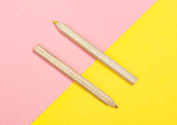 istock Colored pencils on yellow and pink background. 1076932014