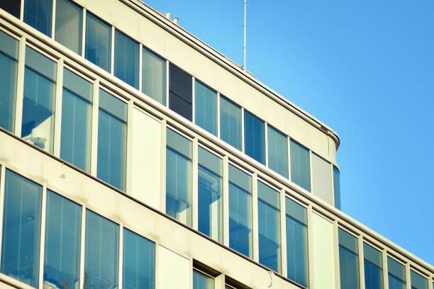 istock Modern office building facade abstract fragment, shiny windows in steel structure. 1076939124