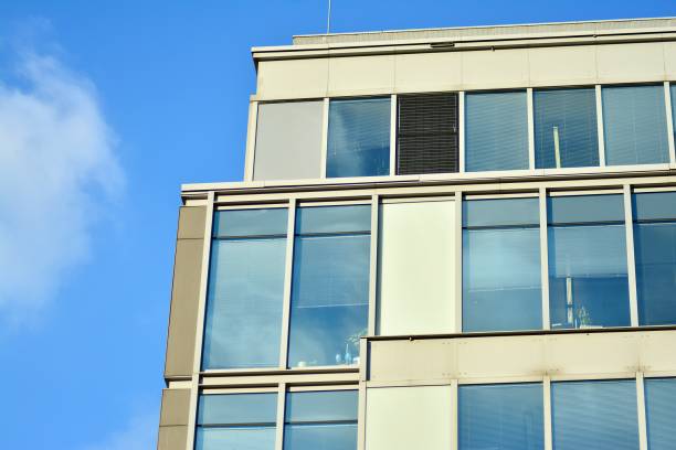 istock Modern office building facade abstract fragment, shiny windows in steel structure. 1076939206