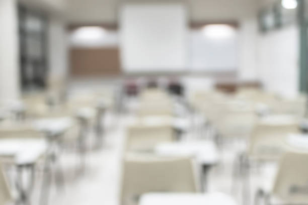 istock Blur classroom education background empty school class lecture room interior view with no teacher nor student 1076945704
