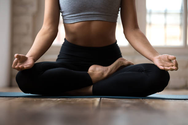 istock Woman practicing yoga, doing Ardha Padmasana exercise, Half Lotus pose 1076946878