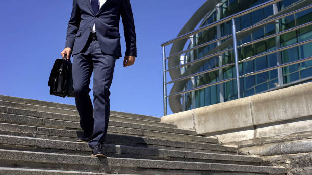 istock Man in suit feeling back pain, sedentary lifestyle, spinal disc herniation 1076947042