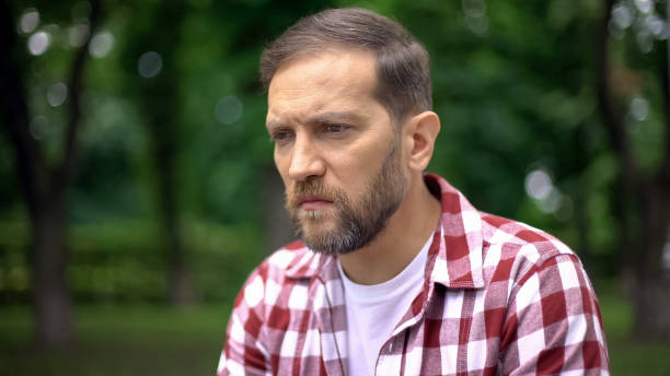 istock Blind man sitting on bench in park, feeling despair and helplessness, awareness 1076947624