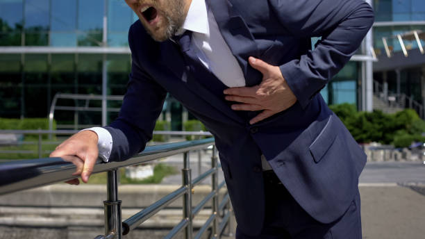 istock Stressed manager having heart attack outdoors, strong chest pain, first aid 1076948782