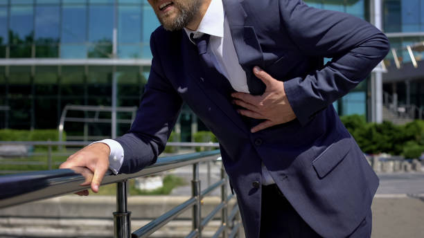 istock Office worker having heart attack outdoors, strong chest pain, first aid, health 1076949094