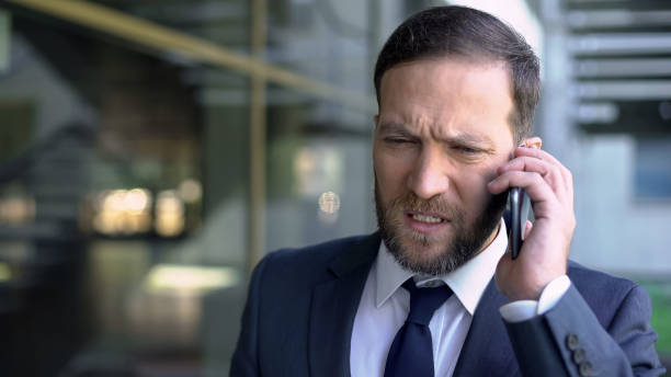istock Worried businessman talking on phone, finding out about his bankruptcy, problems 1076949240
