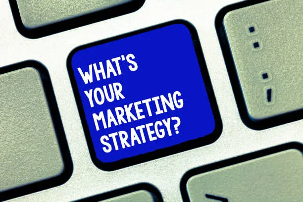 Photo of Conceptual hand writing showing What S Is Your Marketing Strategyquestion. Business photo showcasing Establish your advertising plan Keyboard Intention to create computer message keypad idea.