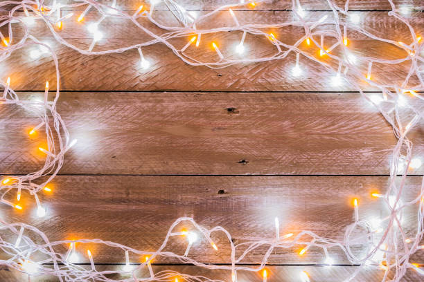 istock christmas light wire on wooden floor background with free copy space 1076954266