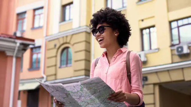 Beautiful woman tourist looking map, searching for city sightseeing places