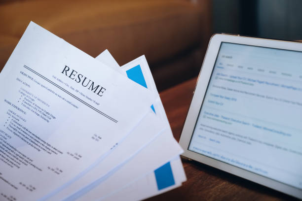 woman holding resume application with using tablet digital to job search on internet. applying for a job concept. woman holding resume application with using tablet digital to job search on internet. applying for a job concept. military recruit stock pictures, royalty-free photos & images