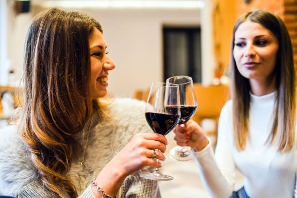 istock Young Women drinking red Wine, toasting 1076970448